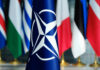 Russian Ghost Plane Taunts Poland NATO flag in front of various national flags