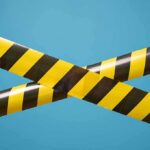 caution tape crossing on blue background