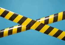 caution tape crossing on blue background