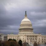 United States Capitol building under dark storm clouds
