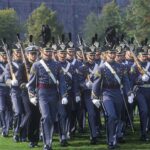 military cadets marching in formation with rifles