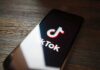 TikTok Blood Money: U.S. Moves In Smartphone displaying TikTok app logo on screen