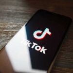 TikTok Blood Money: U.S. Moves In Smartphone displaying TikTok app logo on screen