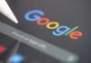 UK Slaps Google — AI Pullback Begins Close-up of a Google search interface on a tablet
