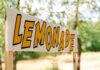Lemonade stand sign with bold yellow letters outdoors