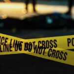yellow police tape at a nighttime crime scene