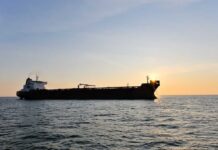 War Zone: Hormuz Suddenly Turns Deadly Cargo ship sailing on the ocean during sunset