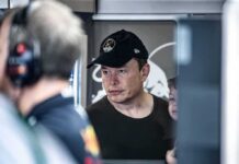“America Is Toast” — Musk Goes All‑In man in black cap looks ahead indoors