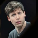 A man with a thoughtful expression during a conference