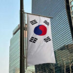 South Korean flag hanging among tall buildings
