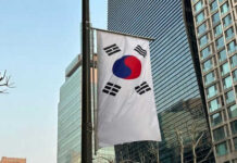 Escape Washington? Engines Say Otherwise South Korean flag hanging among tall buildings