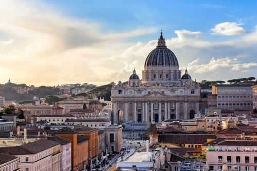 vatican2445310669 St Peters Basilica with surrounding cityscape at sunset