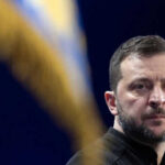 Person with short hair next to blurred yellow flag