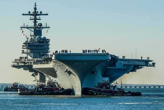 shutterstock_1018972291 Aircraft carrier guided by tugboats in a harbor