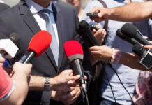 Ethics Alarm Over Talarico Office Romance Person in suit surrounded by microphones during media interview