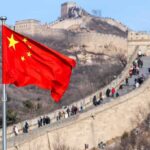 Walk Away From China? Rubio Slams ‘Reckless’ Move Chinese flag waving with the Great Wall in the background
