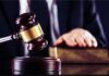 Insanity Loophole Frees Knife-Wielding Intruder Judge's gavel striking block with hand on book in background