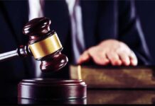 Insanity Loophole Frees Knife-Wielding Intruder Judge's gavel striking block with hand on book in background