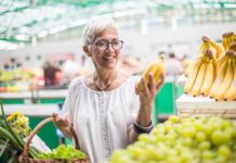 30% Off Food Could Put Some Out of Business Woman shopping for bananas at a market