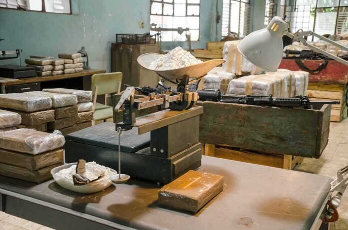 shutterstock_1188174268 industrial scale with white powder in a cluttered warehouse