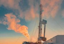 Iran Fallout Hammers Chile’s New President Oil drilling rig at sunset releasing steam
