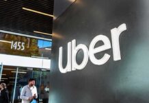 Drivers Axed by Bots? Uber Slammed uber logo on office wall
