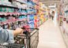 Grocery Giant Folds—Summer Prices Slashed Shopper pushing a cart down a supermarket aisle
