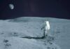 Astronaut walking on the Moon with Earth in the sky