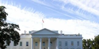 White House with front fountain and flag