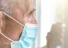 Outrage In Tucson—Senior Targeted, Crowd Strikes Back Older man wearing a surgical mask looking out a window