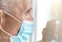 Outrage In Tucson—Senior Targeted, Crowd Strikes Back Older man wearing a surgical mask looking out a window