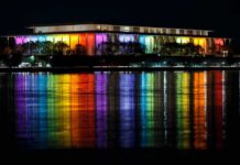 Safety Meltdown Threatens Iconic DC Venue Modern building lit in rainbow colors reflected on water at night