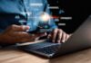 Left-Leaning Bots — Democracy On The Line Person using smartphone and laptop with AI hologram
