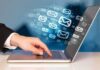 Google Bypasses Spam—Brace For Politics Hand typing on laptop with email icons emerging from screen