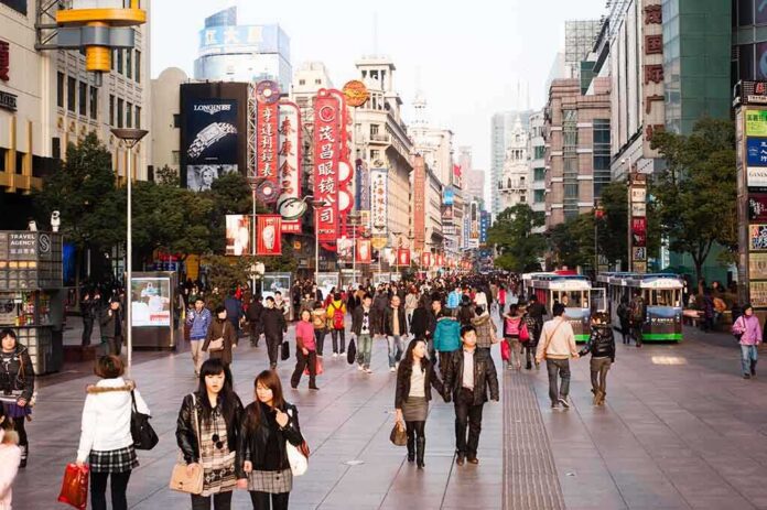Crowded shopping street with pedestrians and storefronts
