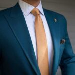 Shielded Staffer Vanishes Before Questioning Teal suit jacket with gold tie