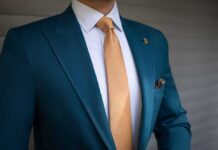Shielded Staffer Vanishes Before Questioning Teal suit jacket with gold tie