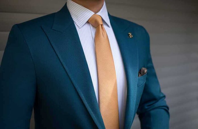 Teal suit jacket with gold tie
