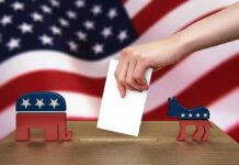 Boos Don’t Vote – Kansas Stays Red Hand casting ballot between Republican elephant and Democratic donkey