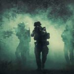 Rail Hit Near Poland – Alliance Hardens Soldiers move through dense smoke in a forest