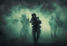 Rail Hit Near Poland – Alliance Hardens Soldiers move through dense smoke in a forest