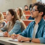 students in a lecture hall, including Angela Bettis among the attendees