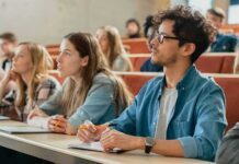 Elite Campus Meltdown: CMU Crackdown Shocks Academia students in a lecture hall, including Angela Bettis among the attendees