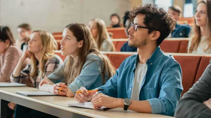 shutterstock_1077839504 students in a lecture hall, including Angela Bettis among the attendees