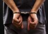 No-Bond Lockup – Probe Nabs Shapiro Threat Suspect person with hands cuffed behind back