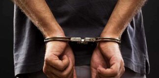 person with hands cuffed behind back