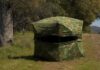 camouflage hunting blind in a grassy woodland