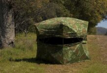 camouflage hunting blind in a grassy woodland
