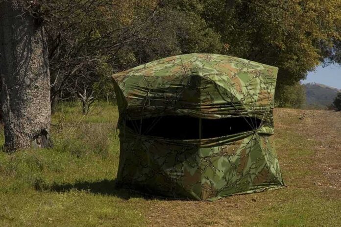 shutterstock_10986196 camouflage hunting blind in a grassy woodland