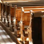 wooden church pews in sunlight